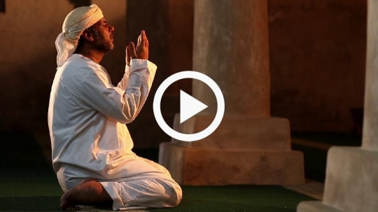 Old man praying at the mosque