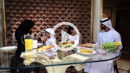 Arab family sitting together having breakfast|