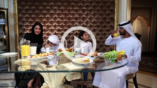 Arabian family sitting together having breakfast|