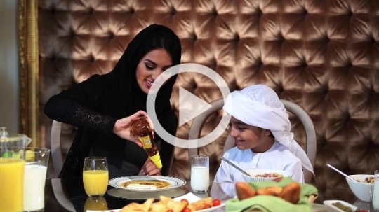 Arab mother preparing her sons food|