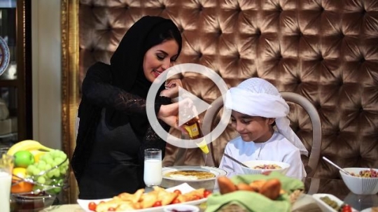 Middle Eastern woman preparing the boys breakfast|