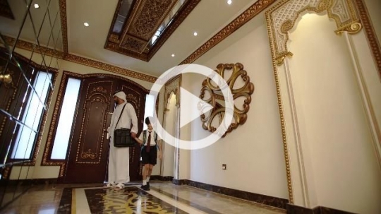 Arab man and boy entering the house|