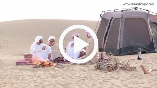 Friends sipping coffee outside camp