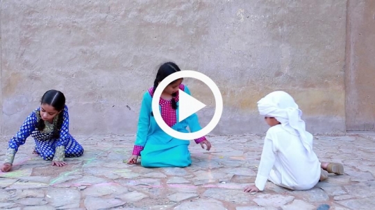 Kids sketching with chalk