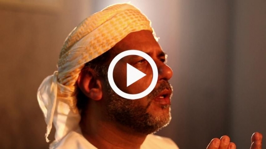 Close-up of man praying at the mosque