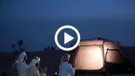 Friends praying outside camp