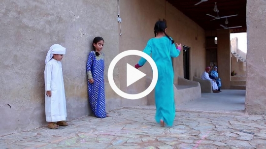 Kids playing hopscotch outside