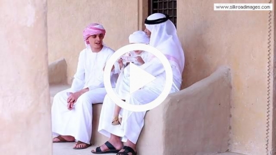 Boys sitting outside with grandfather
