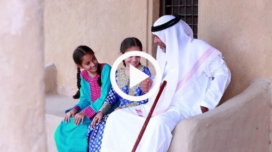 Grandfather greeting girls