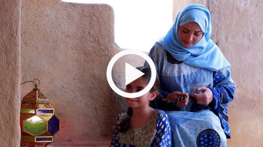 Mother fixing daughters hair