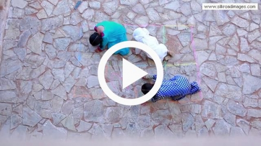 Top view of kids sketching on the floor