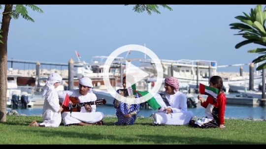 Middle Eastern family sitting together celebrating the UAE National Day|