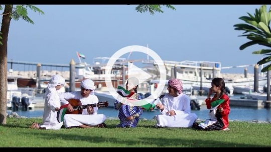 Arab family sitting on the grass representing their country|