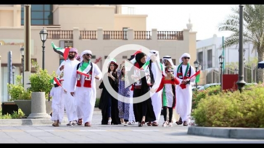 Group of Middle Eastern family and friends celebrating the UAE National Day|