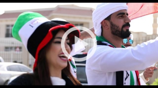 Arab woman and men during a National Day Parade|
