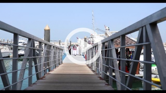 A group of arabs walking towards the dock celebrating the UAE National Day|