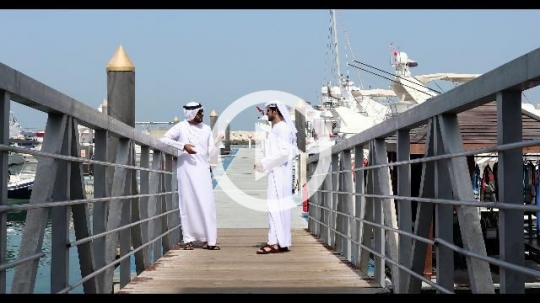 Friends standing on the dock talking to each other|