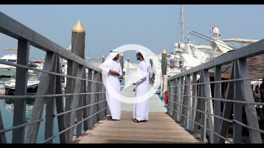 Arab men talking to each other by the dock|