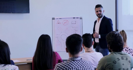 Teacher explaining the driving rules to the students|-