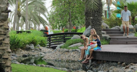 Western man walking towards his family|-