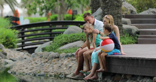 European Family sitting together at the lake|-