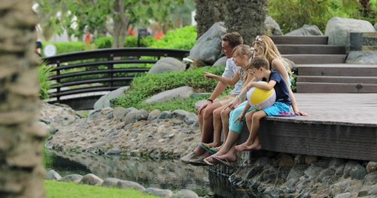 Western Family sitting together at the lake|-