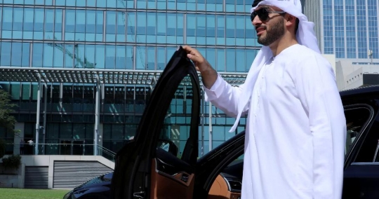 Arab Businessman closes the door of the car and walks|-