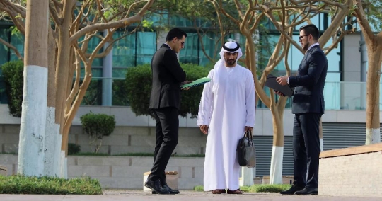 Businessmen standing talking to each other|-