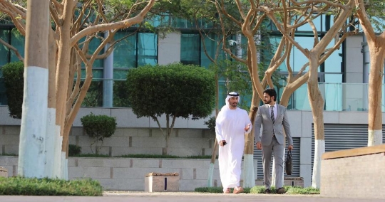 Businessmen walking together talking|-