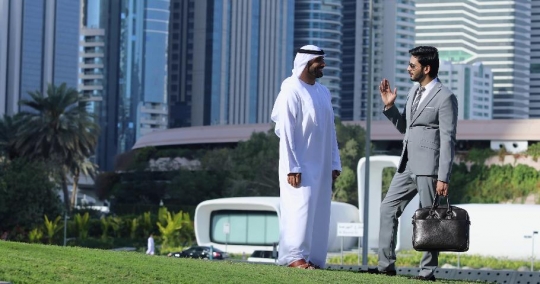 Businessmen standing talking to each other|-