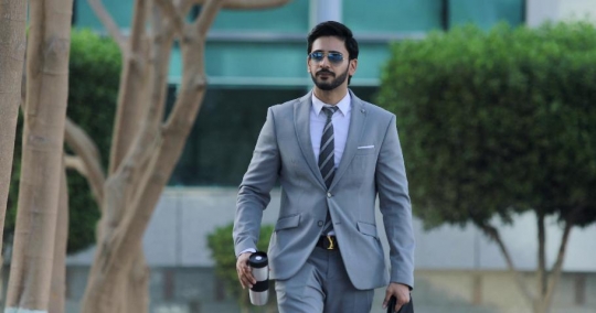 Expat Businessman walking drinking coffee|-