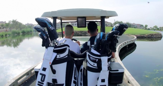 Men driving the golf cart around the resort|-