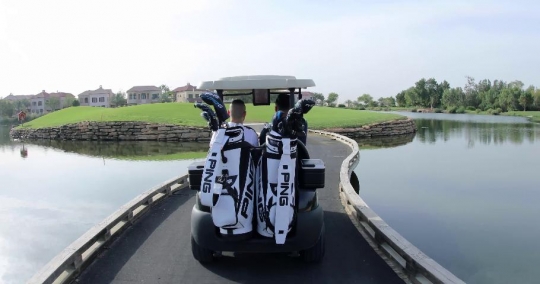 Men driving the golf cart|-