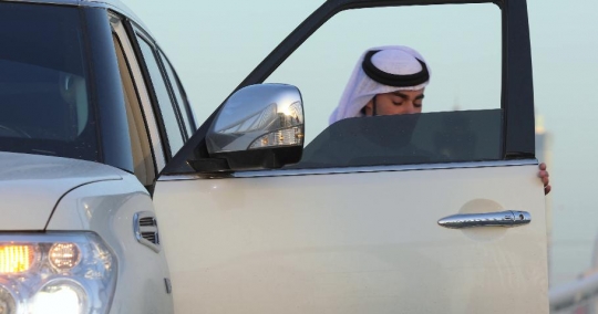 Middle Eastern man stepping out of his car|-