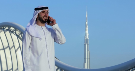 Businessman standing talking on the phone|-