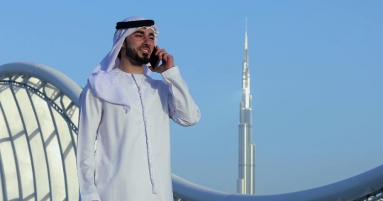 Middle Eastern man talking on the phone|-