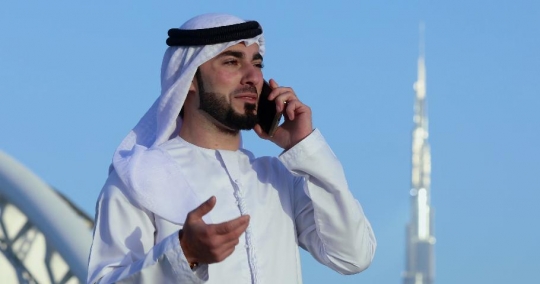 Middle Eastern man talking on the phone|-