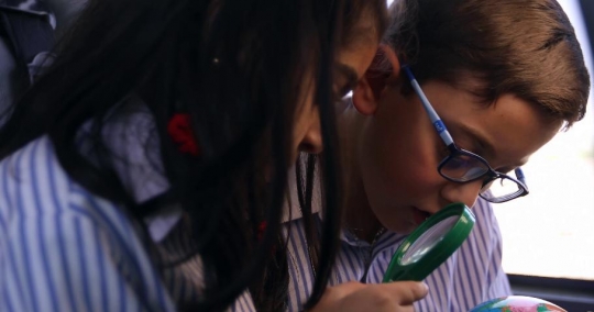 School kids looking at the globe|-
