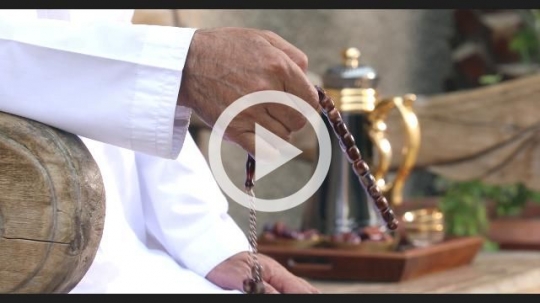 Close up of an Arab Man praying using his Misbahah|