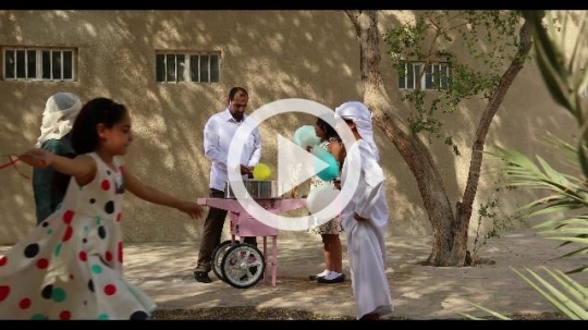 Arab man offering cotton candy to the young kids|