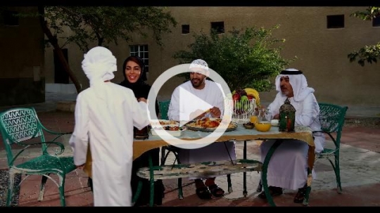 Arab boy walking towards his family carrying a Ramadan Lantern|