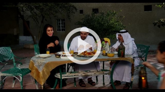 Middle Eastern family praying before Iftar |