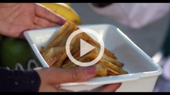Arab woman offering food to the man|