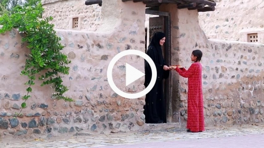 Girl sharing food with neighbor