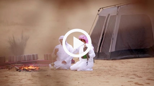 Friend sipping coffee outside the camp