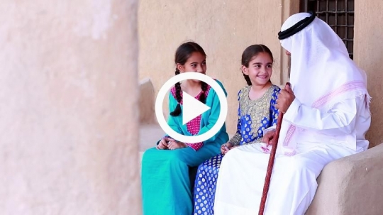 Girls enjoying company of grandfather