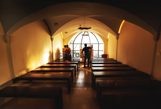 Inside Madaba Church - Warm Light and People Setting Up