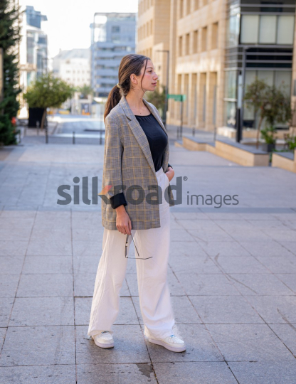 Professional Woman Smiling and Reflecting on Business Opportunities in Al Abdali, Amman Boulevard