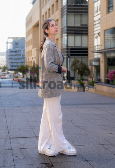 Professional Woman Smiling and Reflecting on Business Opportunities in Al Abdali, Amman Boulevard