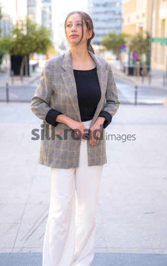 Professional Woman Smiling and Reflecting on Business Opportunities in Al Abdali, Amman Boulevard